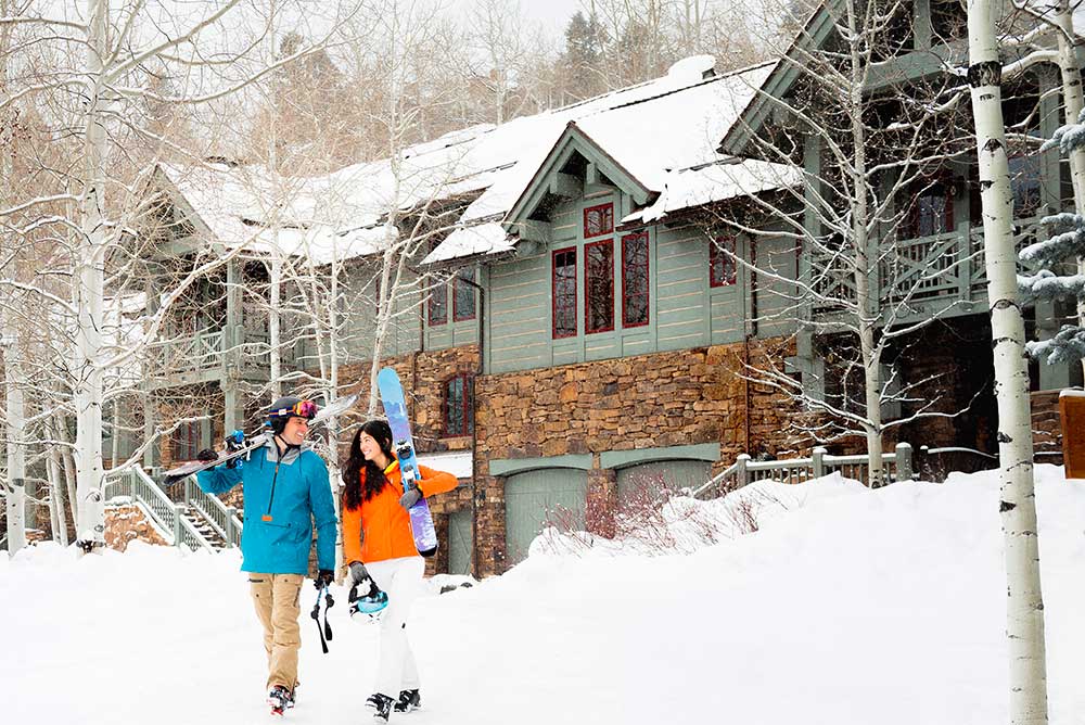 Couple walking with skis in Beaver Creek