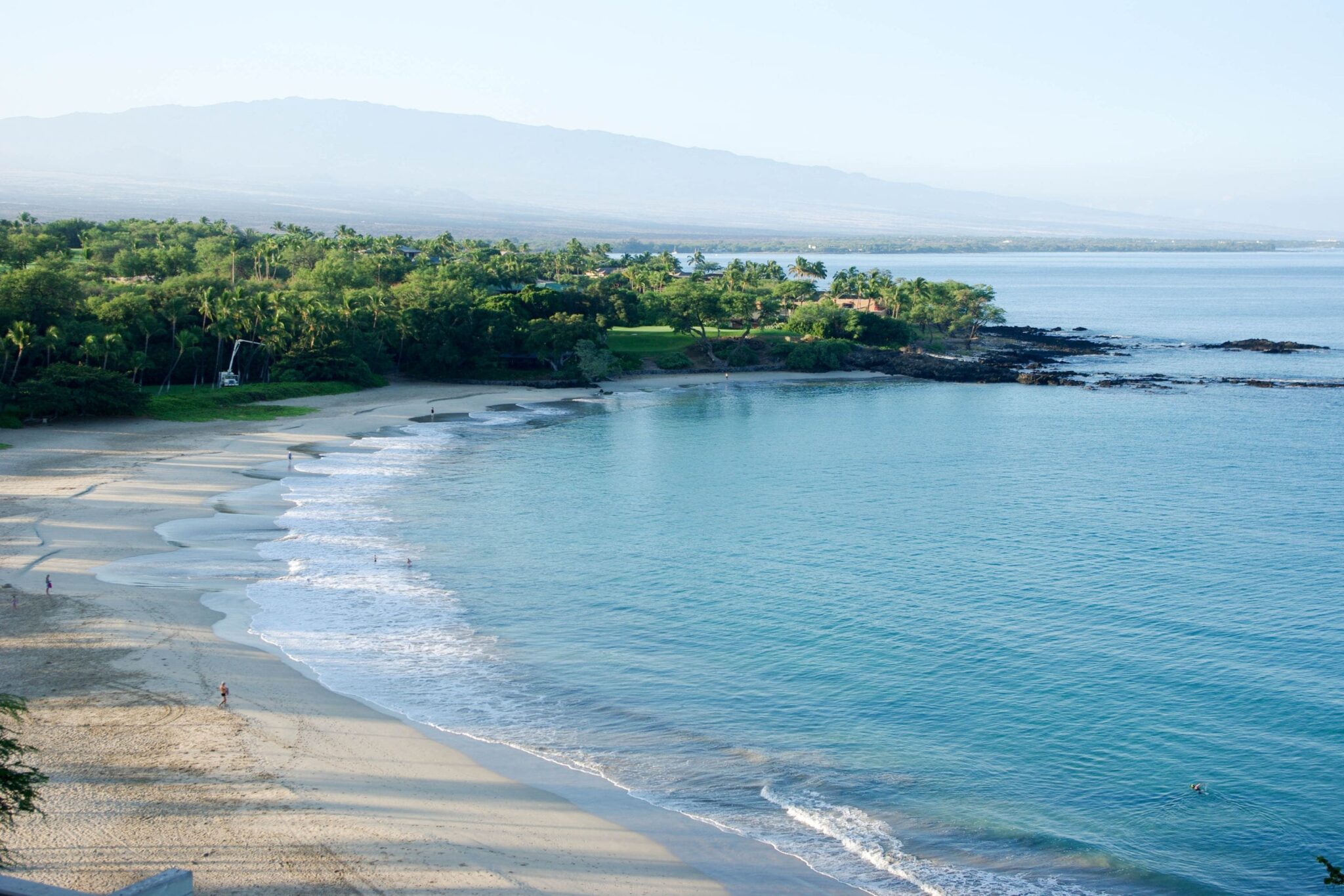 aerial shot of the crescent shaped Mauna Kea beach in Hawaii