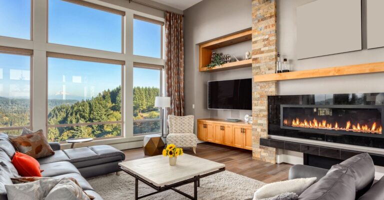 interior living room of a mountain home with huge windows and a stunning view